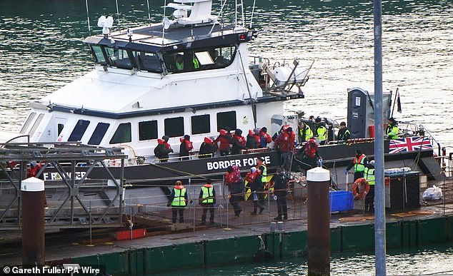 A group of people thought to be migrants are brought in to the Border Force compound in Dover in January