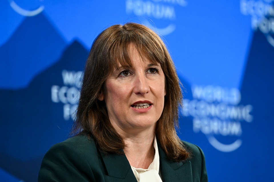 Headshot of a woman with brown hair and bangs speaking against a blue backdrop with the World Economic Forum logo.