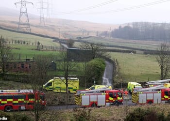 A light aircraft with two people on board has crashed near a lake next to the M62 in Greater Manchester