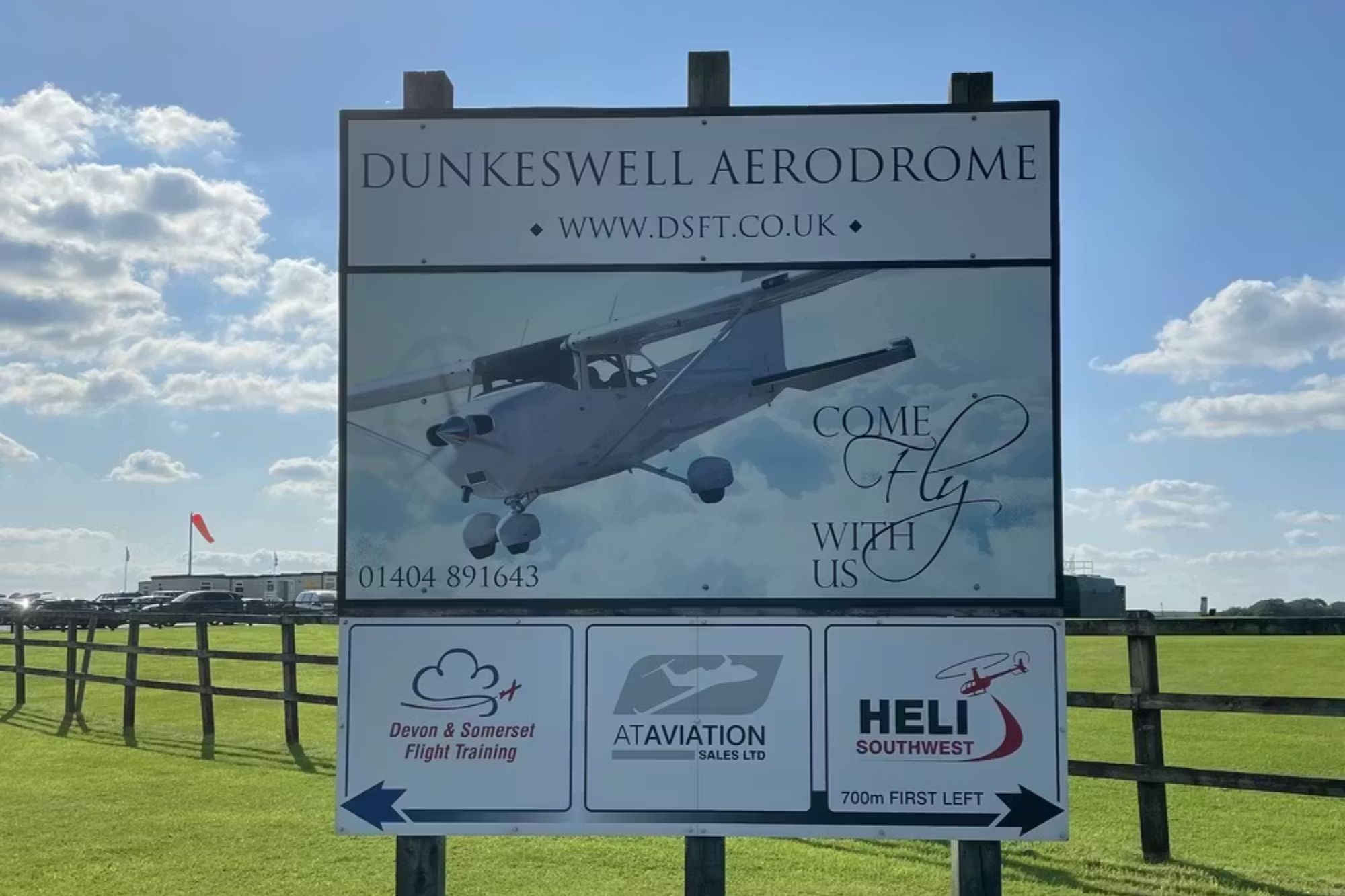 An image collage containing 1 images, Image 1 shows Sign for Dunkeswell Aerodrome, featuring flight training, aircraft sales, and helicopter services