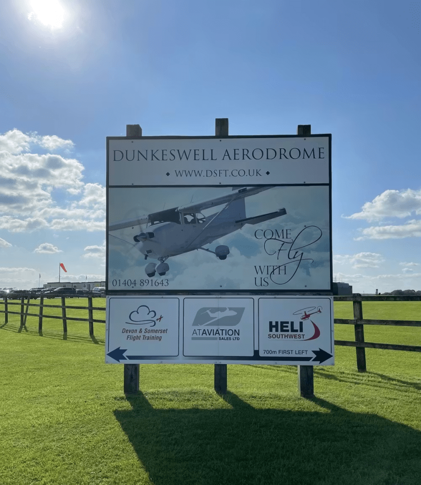 Sign for Dunkeswell Aerodrome, featuring flight training, aircraft sales, and helicopter services.
