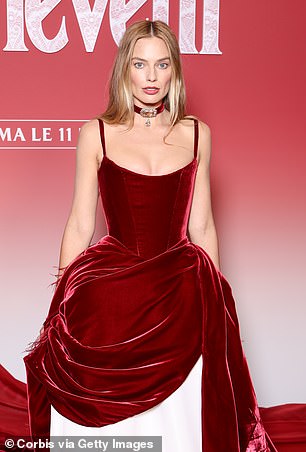 Taking to the red carpet, Margot once again paid tribute to the film's Georgian era in a red velvet Chanel gown with a dramatic train