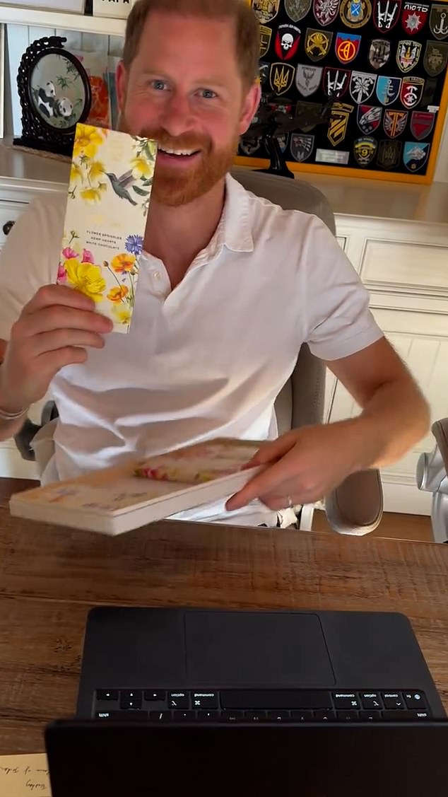 Harry grins at the camera - holding up the bar - and says 'yes please' and proceeds to hand back the box