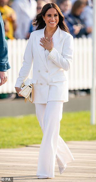 Stylists revealed how a white suit became a must-have for royals after Meghan (pictured) and Kate were among those to wear the ensemble