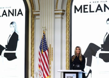 First lady Melania Trump, flanked by posters for "Melania," the documentary about her, delivers remarks before ringing the opening bell at the New York Stock Exchange in New York on Wednesday.