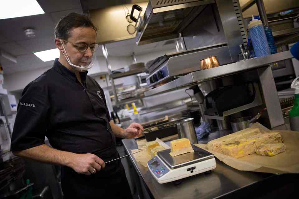 A Michelin-starred chef prepares foie gras for takeaway.