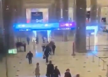 Dramatic footage shows passengers at Dubai's primary international airport fleeing the airport following reports of a strike on one of its terminals