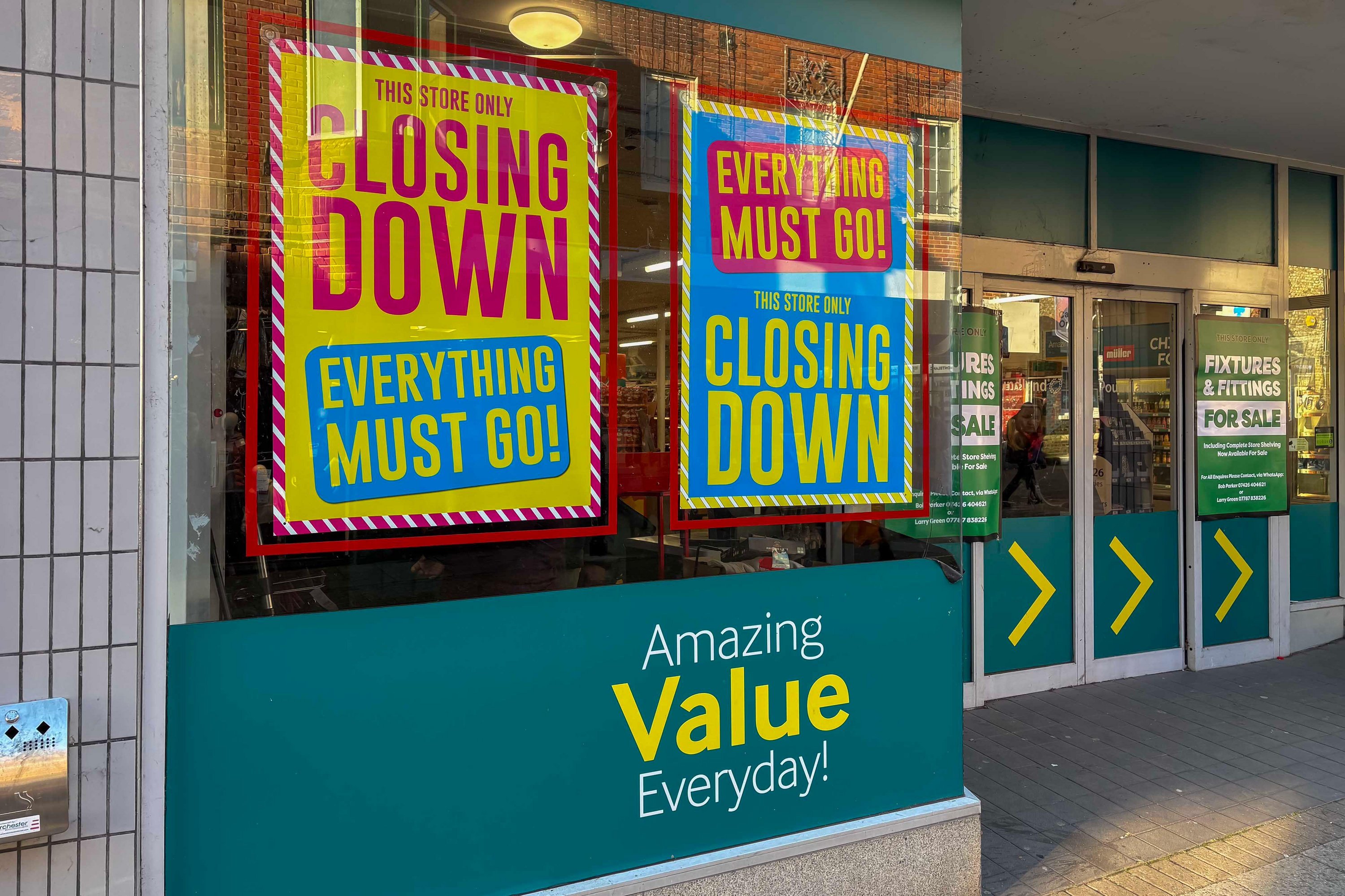 Poundland store with "CLOSING DOWN EVERYTHING MUST GO!" signs in the windows.
