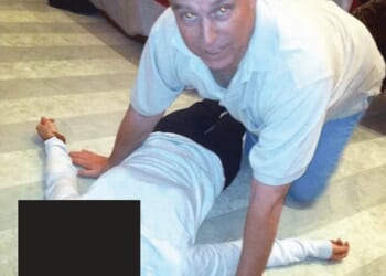 Andrew Mountbatten-Windsor crouched over an unidentified woman which has been released in the latest disclosure of files linked to Jeffrey Epstein