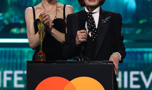 Sharon and Kelly Osbourne make heartfelt speech in honour of Ozzy while Dolly Parton and Robbie Williams pay 'fitting tribute' to the late rocker as he's awarded Lifetime Achievement Award at the BRITs