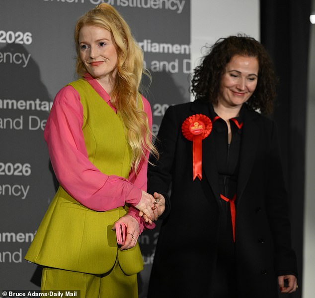 Ms Spencer, a plumber and local councillor, will become the Greens' fifth MP in the House of Commons. She is pictured shaking hands with Labour's defeated candidate Angeliki Stogia