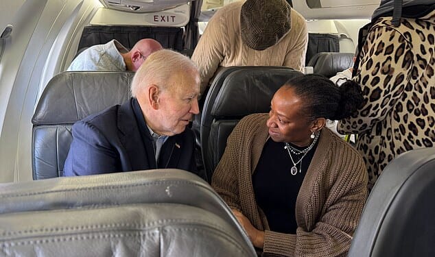 Former President Joe Biden (left) talks with his seatmate (right) on a flight to Columbia, South Carolina on Friday departing from onald Reagan Washington National Airport. Biden was briefly confronted by another passenger over the war in Gaza