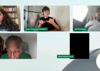 A sign language interpreter, top center, appeared surprised at the passage read during the meeting of a Chicago-area Muslim group.