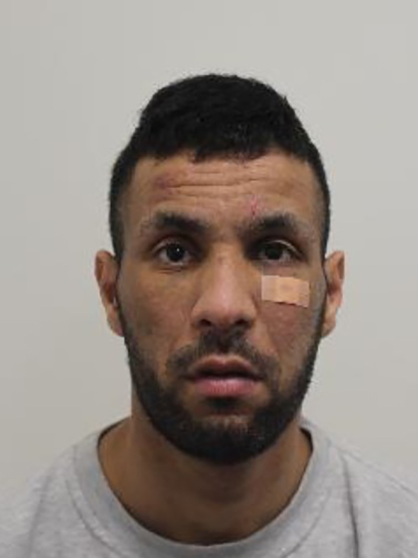 Enzo Conticello, a man with short dark hair, a beard, and a bandage on his right cheek.