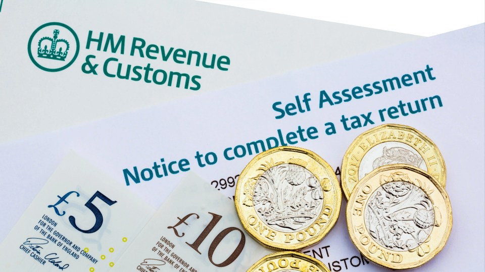 A UK Self Assessment tax return notice with British pound coins and banknotes.
