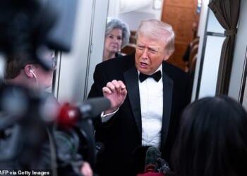 Tuxedo-clad Trump issues latest threat to Iran on Air Force One as he claims 'big powerful ships' are on their way