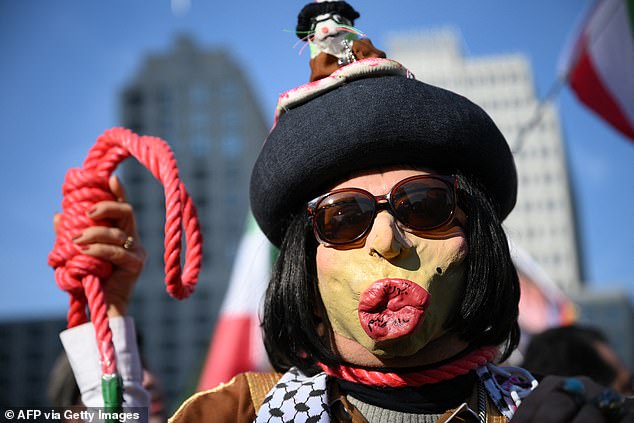 A noose and a demonstrator wearing a makeshift mask of Iran's Supreme Leader Ayatollah Ali Khamenei are seen during a demonstration 'Freedom for Iran' at the square Potsdamer Platz in Berlin, Germany on February 28