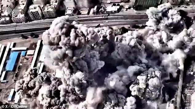 Smoke billows in the aftermath of dozens of Israeli bombs on two buildings in Tehran