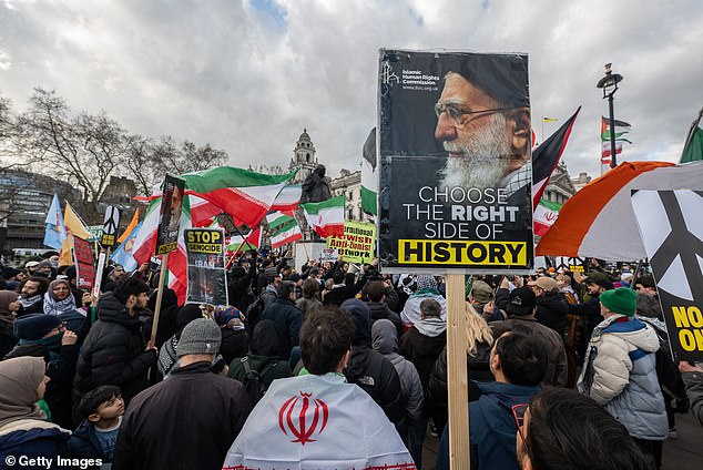 They also brandished signs (pictured) bearing portraits of the Ayatollah Khamenei, Iran's supreme leader, and the slogan, 'Choose the Right Side of History'