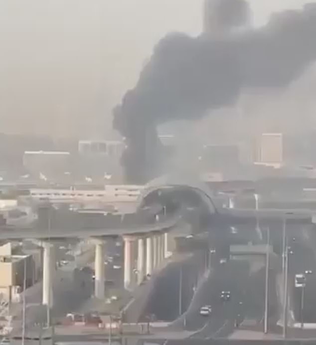 Smoke rises from Dubai International Airport on Sunday morning amid the ongoing crisis