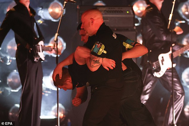 In the middle of Sombr's set, a man came on stage, pushing the singer off his podium in front of the stunned crowd