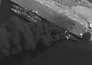 US forces SINK Iranian warship in 'Epic Fury' strikes as satellite pics show black smoke billowing from vessel at port