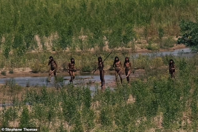 At first it was just four or five of them, off in the distance. But soon there were others coming from the trees. All of them were armed