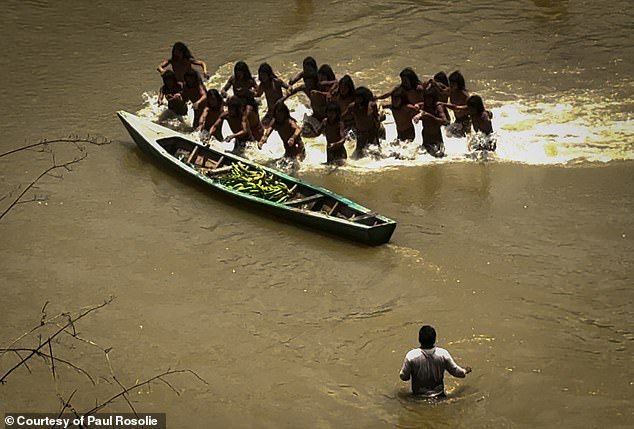 The moment the boat full of plantains was pushed into the river and the tribe rushed forward - Rommel, the interpreter, is in the foreground