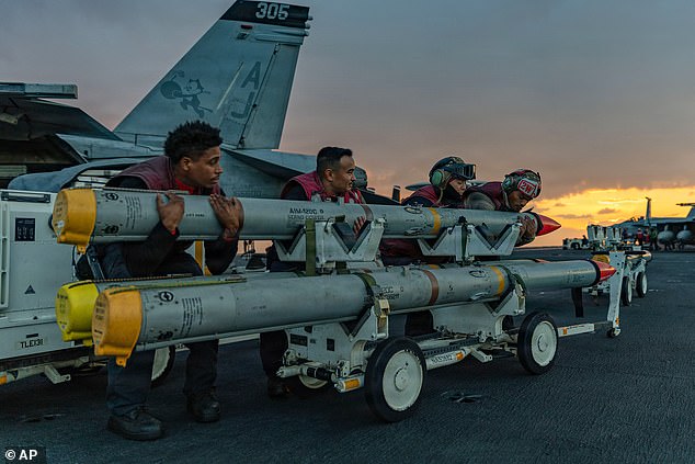 This image provided by U.S. Central Command shows Navy sailors moving ordnance on the USS Gerald R. Ford (CVN 78) in support of Operation Epic Fury, on Saturday