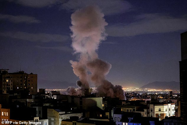A smoke plume rises following a missile strike on a building in Tehran on March 1, 2026. The United States and Israel launched strikes against Iran on February 28