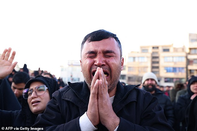 People mourn the death of Iran's supreme leader Ayatollah Ali Khamenei, who was killed in joint US and Israeli strikes, at a square in Tehran on March 1
