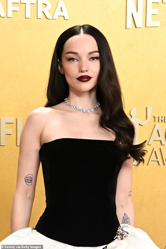 She wore her dark tresses cascading down in waves