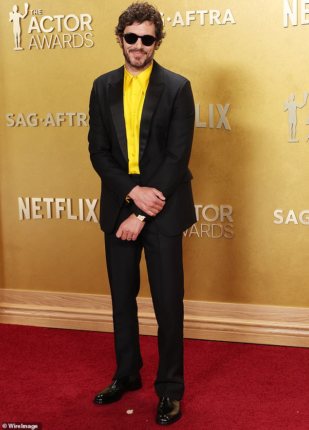 Adam Brody created a buzz as he arrived at the Actors Awards. Brody looked like he was channeling the Cheerio cereal mascot as he donned a black suit and neon-yellow silk button-down. He completed his look with black patent leather dress shoes and a pair of small black sunglasses