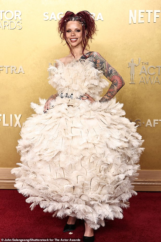 Way too over-the-top! Influencer Snitchery wore a wild, cream-colored gown that was covered in feathers from head-to-toe. The dress also featured a super large and puffy skirt, pairing it with a studded belt and black heels