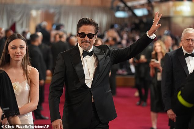 Beaming in a charming floral-embellished dress, she walked alongside her father as cameras flashed around them