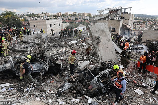 The aftermath of an Iranian rocket hitting Beit Shemesh in Israel, where nine people were killed