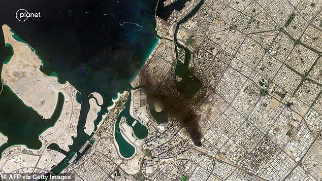 Another satellite photograph showed a plume of smoke billowing near the sea in Dubai following a projectile strike