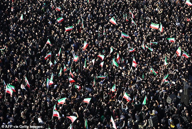 People gather to mourn the death of Iran's supreme leader Ayatollah Ali Khamenei, who was killed in joint US and Israeli strikes, at a square in Tehran on Sunday