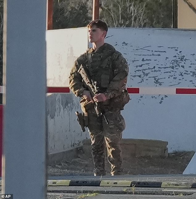 A British soldier stands guards at the main gate of the UK's RAF Akrotiri base on Monday