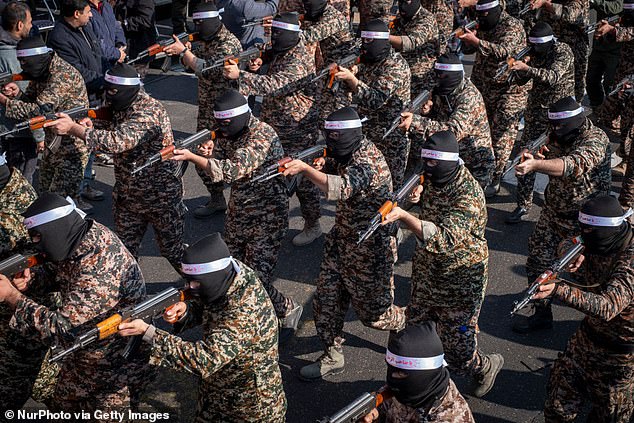 Fears are growing over the possibility of sleeper agents unleashing chaos across Europe. Pictured: Islamic Revolutionary Guard Corps armed personnel wear masks and participate in a military rally in downtown Tehran, Iran, on January 10, 2025