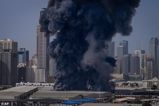 A black plume of smoke rises from a warehouse at the industrial area of Sharjah City in the United Arab Emirates following reports of Iranian strikes in Dubai on March 1