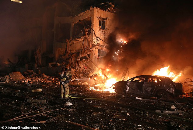 A member of the Israeli security and rescue forces works at the scene where a ballistic missile fired from Iran hit and caused damage in Tel Aviv, Israel, early on March 1