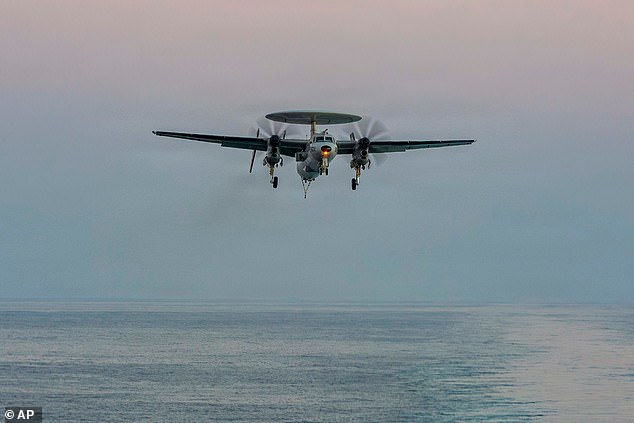 This image provided by U.S. Central Command shows a An E-2D Hawkeye preparing to land on the USS Abraham Lincoln (CVN 72) in support of Operation Epic Fury, on Saturday