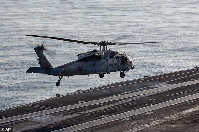 This image provided by U.S. Central Command shows a MH-60S Sea Hawk preparing land on the USS Abraham Lincoln (CVN 72) in support of Operation Epic Fury, on Saturday