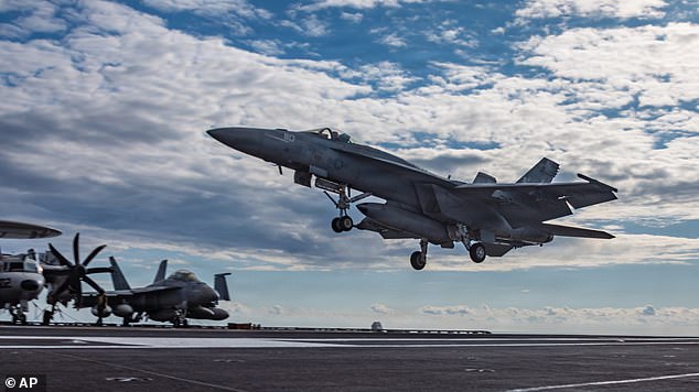 This image provided by U.S. Central Command shows a F/A-18E Super Hornet landing on the USS Gerald R. Ford (CVN 78) in support of Operation Epic Fury, on Sunday