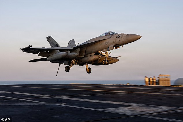 This image provided by U.S. Central Command shows a F/A-18E Super Hornet preparing to make an arrested landing on the USS Abraham Lincoln (CVN 72) in support of Operation Epic Fury, on Sunday