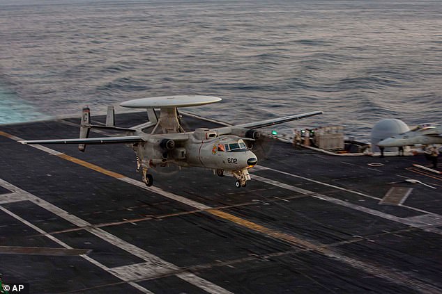 This image provided by U.S. Central Command shows a An E-2D Hawkeye preparing to make an arrested landing on the USS Abraham Lincoln (CVN 72) in support of Operation Epic Fury, on Saturday