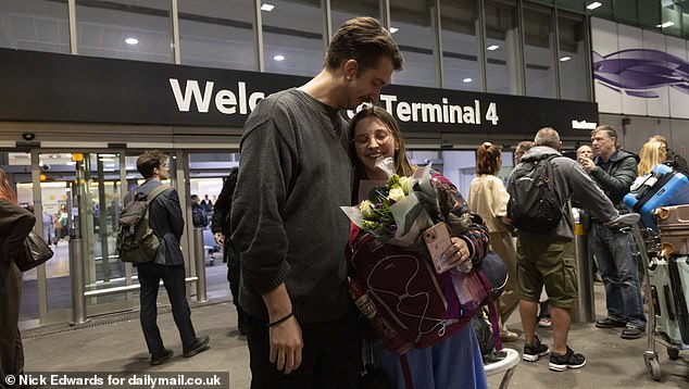 Relieved Brits arrived back home tonight on the only flight back so far from the United Arab Emirates since the Iran attacks. Pictured: Cath and Dom after she touched back down
