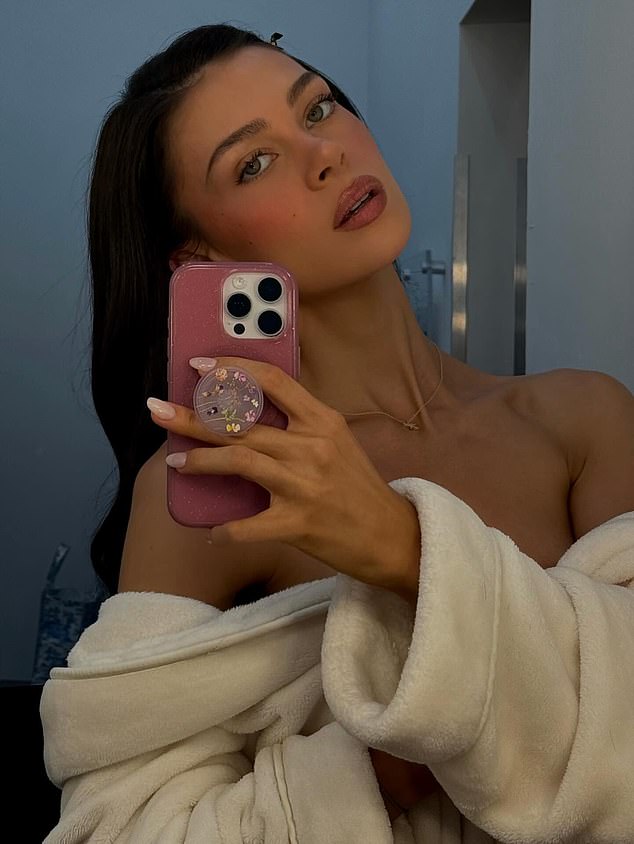 The billionaire heiress, 31, also left little to the imagination in another mirror snap, showing her wearing a cream dressing gown that she pulled down to bare a very daring glimpse of her décolletage