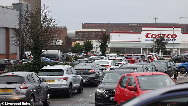 Escalating tensions around the Strait of Hormuz have prompted early signs of panic buying, with queues forming at petrol stations. Pictured: Queues for fuel at Costco in Liverpool today